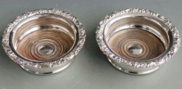Pair of silver plated wine coasters with inset mahogany bases, diameter 15cm