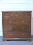 Secretaire chest of drawers with central drawer contatineing a bank of smaller drawers, flanked by
