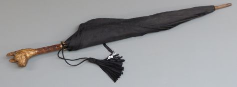 A parasol with gilt metal bull dog head finial set with glass eyes, length approximately 78cm
