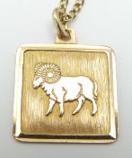 A 9ct gold pendant depicting a ram for Aries birth sign (1.3g) on a 14k gold chain (3.1g)