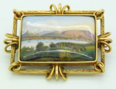 A yellow metal brooch set with an enamel landscape of Geneva, 5.5 x 4.5cm