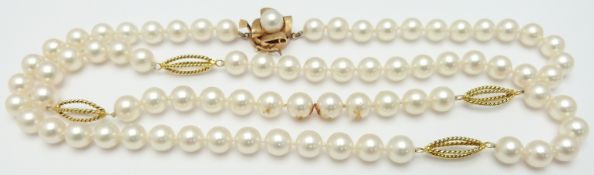 A single strand pearl necklace with 14k gold clasp, the pearls interspersed with gold cages