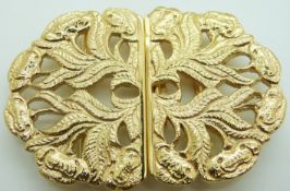A silver gilt buckle with floral decoration