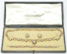 A suite of 9ct gold jewellery made up of knotted and textured links comprising necklace, earrings,