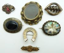 Victorian pinchbeck brooch set with black enamel and banded agate, a horseshoe brooch reading Good