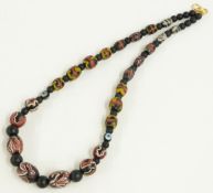 A beaded necklace made up of 18thC Islamic beads