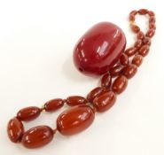 An amber necklace (22g) and large cherry amber bead (43g)