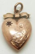 A 9ct rose gold heart pendant set with a garnet in a star setting, 1g