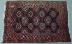 Turkoman kilim with 11 crimson central guls, within a border, 130 x 190cm