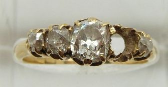 Victorian ring set with four old cushion mine cut diamonds, the largest measuring approximately 0.