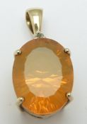 A 9ct gold pendant set with an oval mixed cut fire opal, 3.7g