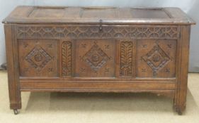 Antique oak coffer of carved panelled construction with peg joints, W131 x D58 x H70cm