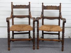 Pair of oak carver chairs with seagrass seats and carved decoration, 96cm high