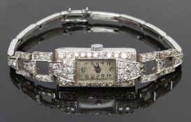 Art Deco platinum ladies wristwatch with diamond set case and bracelet, blued hands, black Arabic