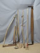 Collection of vintage farming/gardening tools including a scythe, two handled saw etc