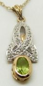 A 9ct gold pendant set with a oval peridot and diamonds, 2.5 x 1cm, 1.9g