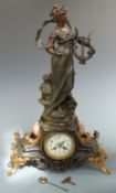 Early 20thC French figural clock in bronzed spelter finish depicting La Voix de la Lyre, signed
