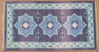 Retro 60's/70's kilim with deep blue ground and central star design, 127 x 67cm
