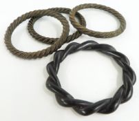 Three inlaid horn bangles and a wooden bangle