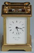 Carriage clock in brass case with reeded decoration, enamel Roman dial signed Morrell and Hilton,