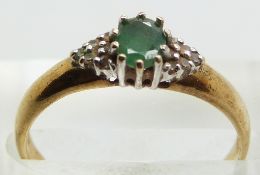 A 9ct gold ring set with an emerald and diamonds, 1.6g, size N