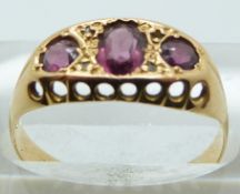 An 18ct gold ring set with three garnets, Birmingham 1919, in original box, 2.6g, size O