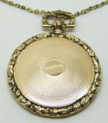 Victorian locket with engine turned decoration and foliate border (4cm diameter, 15g) and a yellow