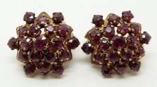 A pair of 14k gold earrings set with clusters of round cut rubies, 2.2cm diameter, 10.6g