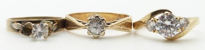 Two 9ct gold rings set with cubic zirconia and another ring, 6.9g
