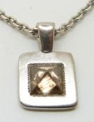 De Beers 18ct white gold pendant set with an uncut brown diamond and a small round cut diamond, 15.