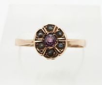 A 9ct gold ring set with pink paste and seed pearls, Chester 1913, 0.9g, size P