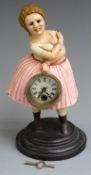 Cast iron figural clock in the form of a lady holding a clock, with automaton moving eyes, 30cm