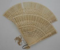 Two late 19thC/early 20thC Chinese pierced ivory fans, each approximately 17.5cm in length