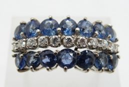 A 14k white gold ring set with a row of round cut diamonds and two rows of cornflower blue