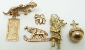 A collection of 9ct gold to include tiger, bagpiper, elephant, St Christopher, etc, 15,7g