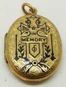 Victorian engraved locket with engraved decoration and black enamel script 'in memory', 3 x 2cm
