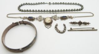 A silver bangle, cameo and filigree necklace, Victorian silver brooch, silver horseshoe and paste
