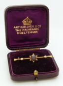 A 9ct gold brooch set with a garnet, in original Cheltenham box