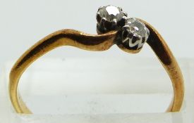 An 18ct gold ring set with two diamonds, 2.3g, size R