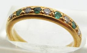An 18ct gold half eternity ring set with alternating emeralds and diamonds, 4.3g, size K