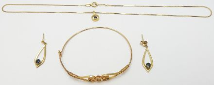 A suite of 9ct gold jewellery set with sapphires comprising bangle, earrings and necklace, 10.2g