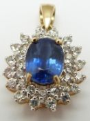 A 9ct gold pendant set with an oval cut kyanite surrounded by diamonds
