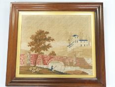 A 19thC wool embroidery of a man fishing by a bridge, in Regency rosewood frame