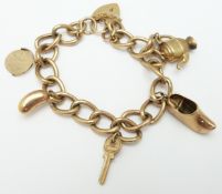 A 9ct gold curb link charm bracelet with five charms, 16.7g