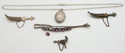 A silver locket, filigree knife brooches and a bracelet set with paste