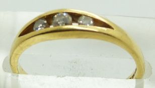 An 18ct gold ring set with three diamonds, 2.5g, size N