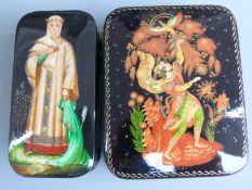 Two Russian lacquer boxes, one depicting a lady in traditional dress (approximately 5cm x 10cm x 2.