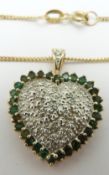 A 9ct gold heart shaped pendant set with diamonds and emeralds on a 9ct gold chain, 5.5g