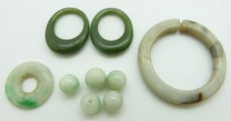 Two nephrite jade rings, jade disc, jade ring and jade beads