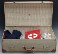 WWII era nurse's cape, hat, first aid box, vintage first aid and anatomy books all in a vintage